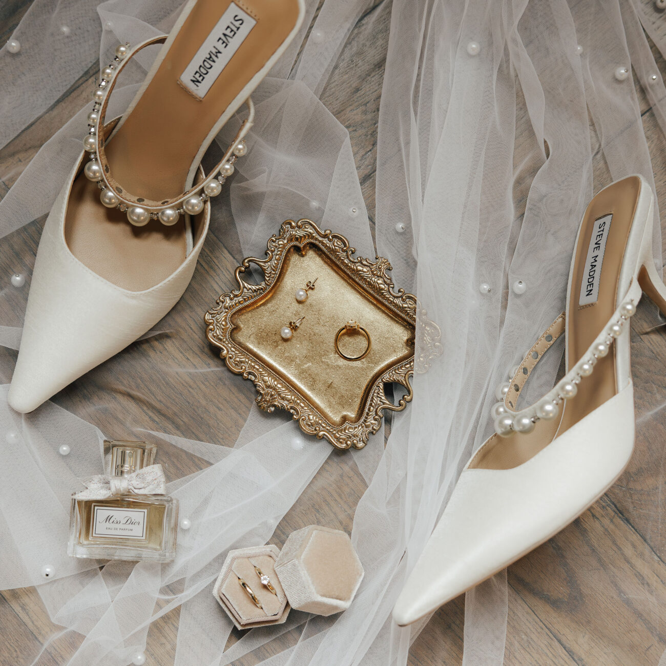 Detailaufnahme von Eheringen auf Leinenstoff mit Blüten Harmonisches Farbschema in einem Flatlay zur Hochzeit Liebevolle Details als Teil des Hochzeitskonzepts